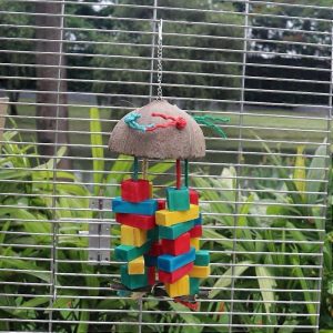 Foraging bird toy made from a natural coconut shell and colorful wooden blocks